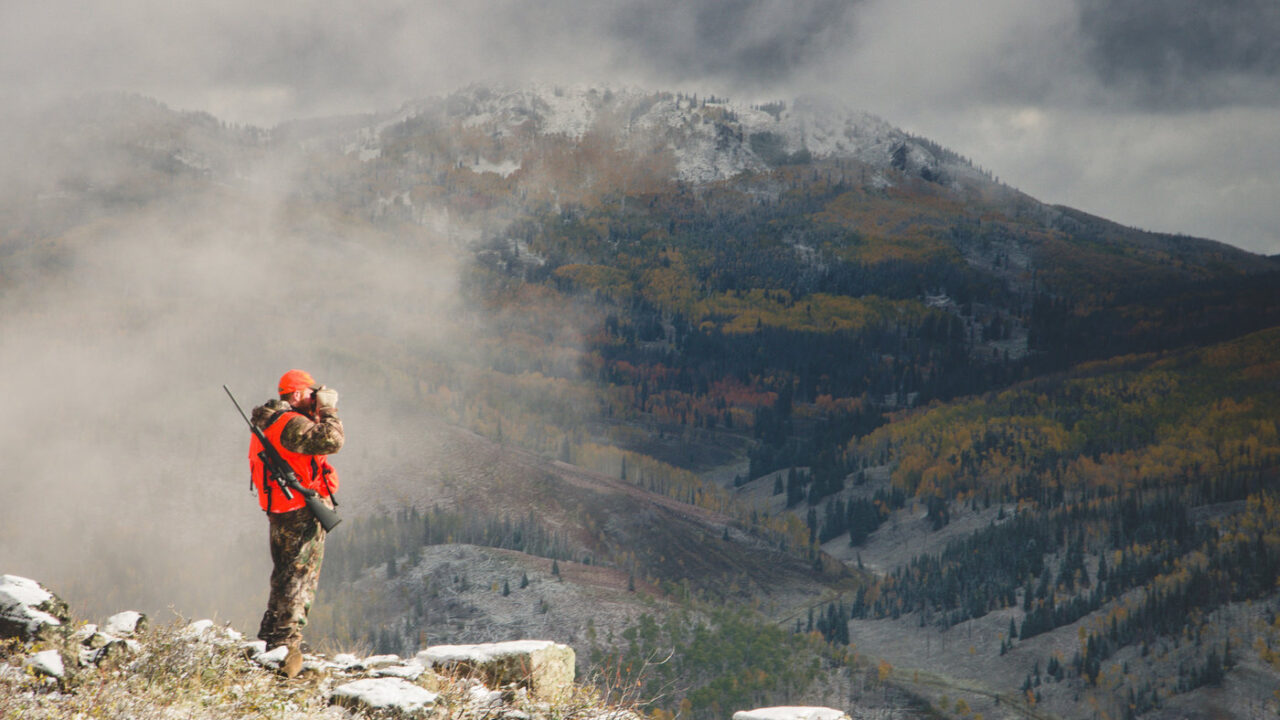 elk hunter glassing majestic valley with fog - credit Howard Communications