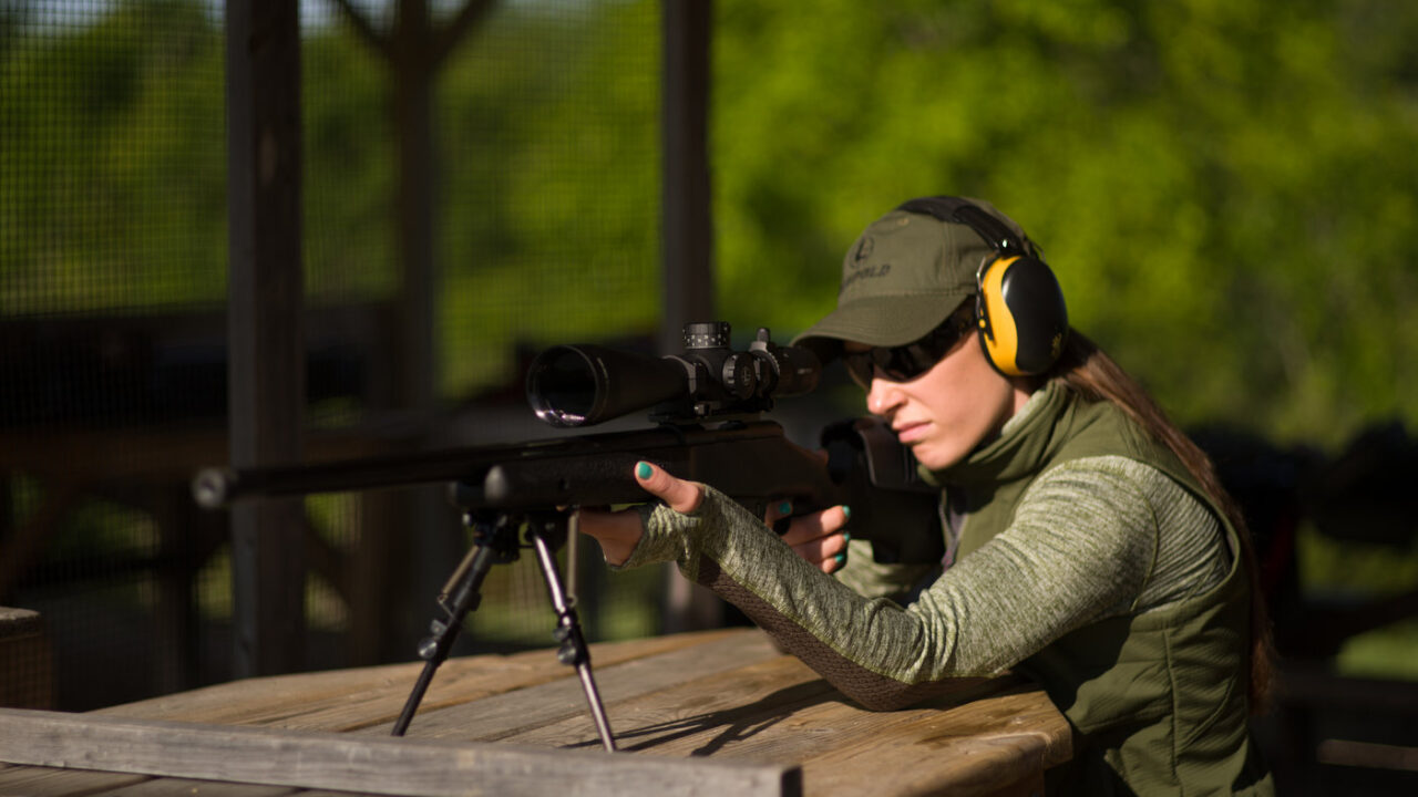 A shooter sights in a rifle on a shooting bench at a gun range. View More: https://howardcommunications.pass.us/hcphotolibrary
