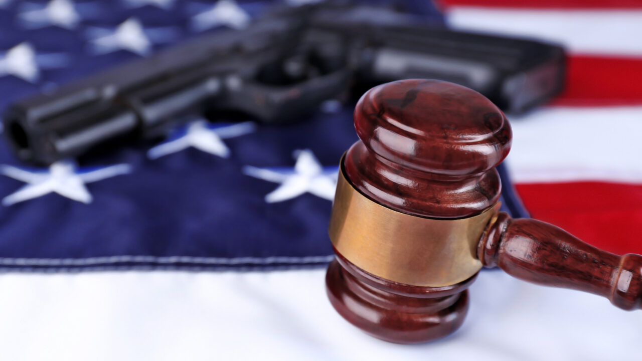 Gavel with gun on background of USA flag