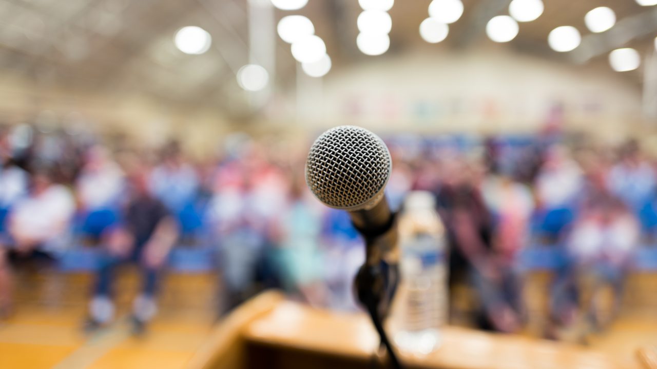 Close up of microphone on a podium in an auditorium